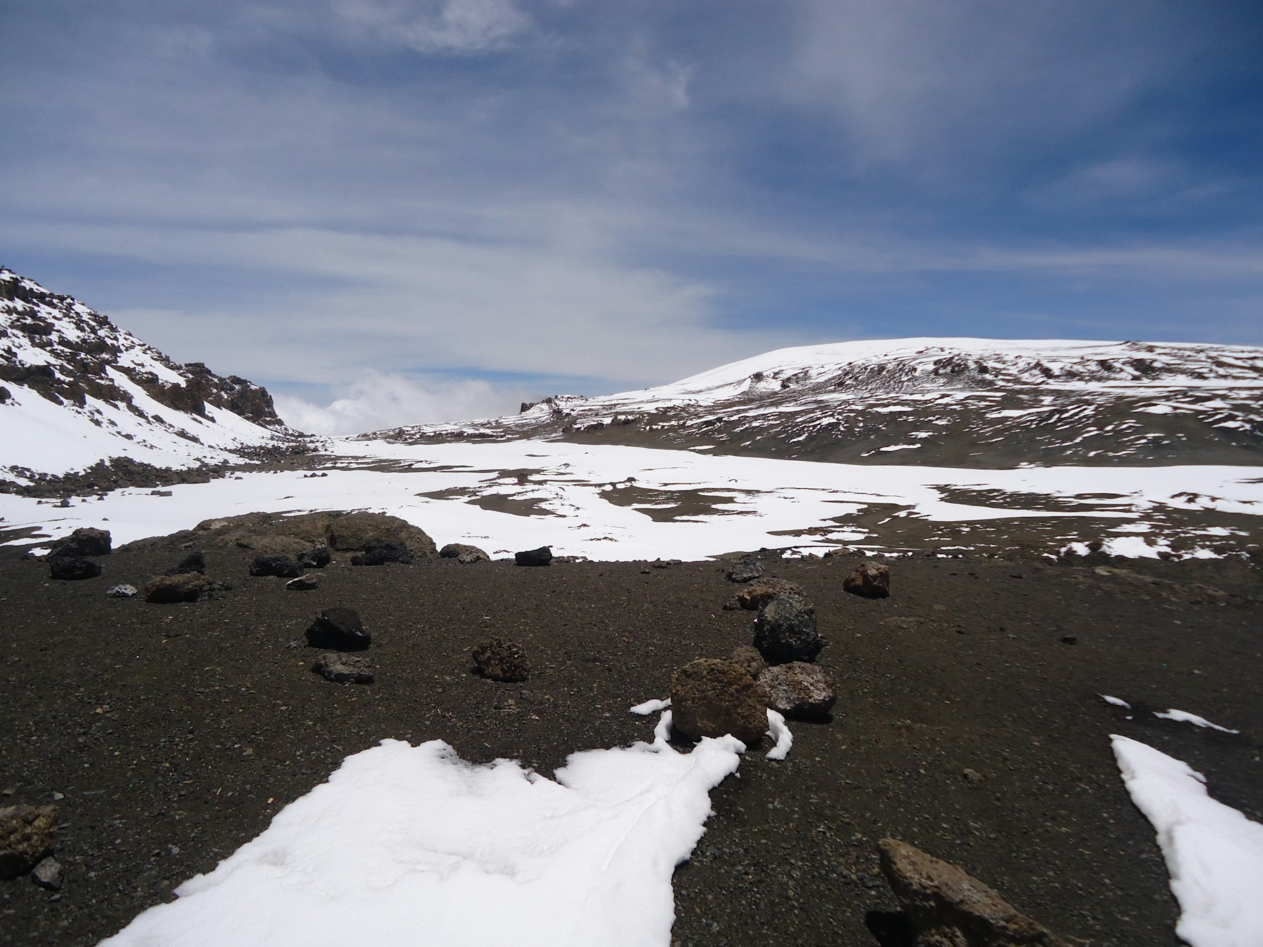 Snow and volcanic terrain on the upper slopes near Uhuru Peak on Mount Kilimanjaro.